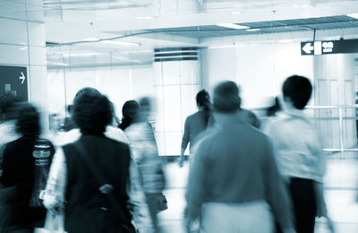 Rear view of people walking in corridor