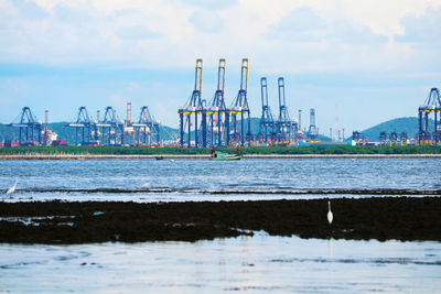 Pier at harbor against sky