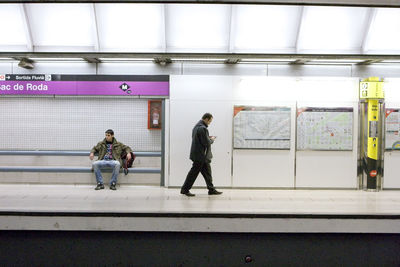 Rear view of people at railroad station