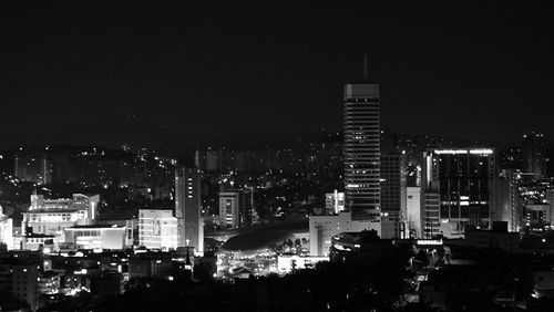 High angle view of illuminated buildings against sky at night