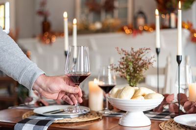 Cropped hand of woman preparing food on table