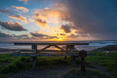 Scenic view of beach against sky during sunset