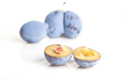 Close-up of apple on table against white background