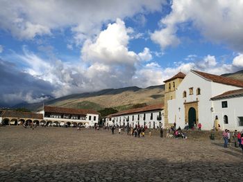 View of town square against cloudy sky