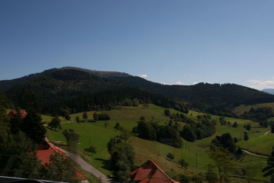 Scenic view of landscape and mountains against clear sky