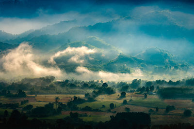 Scenic view of landscape and mountains during foggy weather