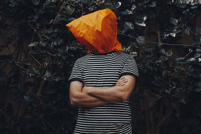 Portrait of a man hiding covering his head with a shopping bag
