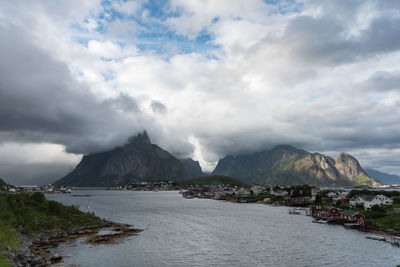 Scenic view of sea and mountains against sky