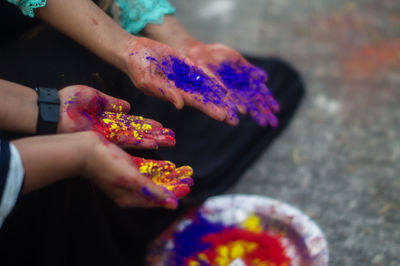 Cropped hands with powdered paint