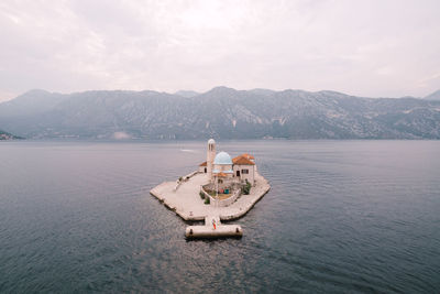 Ship in sea against mountains