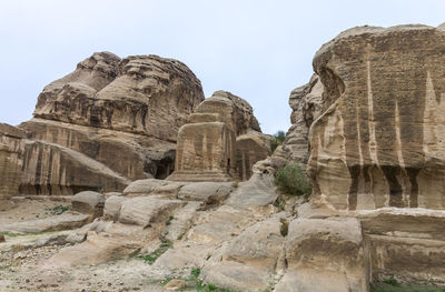 Low angle view of rock formations against sky