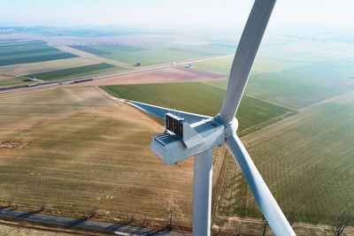 Aerial view of close up windmill turbine in countryside area, wind power 