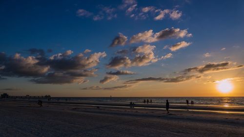 Scenic view of beach against sky during sunset