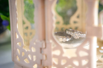 Close-up of wedding rings in container