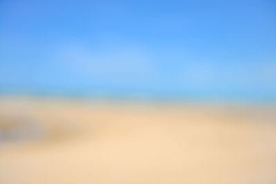 Defocused image of landscape against clear blue sky