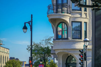 Low angle view of street light against blue sky