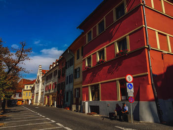 Street amidst buildings in city against sky