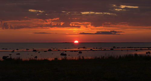 Scenic view of sea against romantic sky at sunset