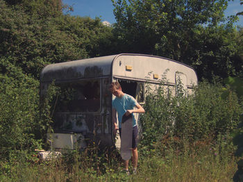 Man standing on field against trees