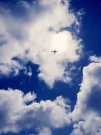 Low angle view of airplane flying in sky