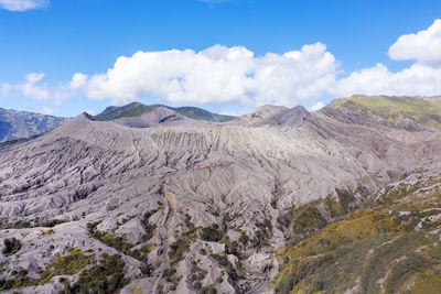 View of volcanic landscape against cloudy sky