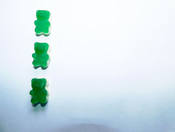 High angle view of green paper over white background
