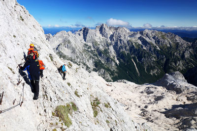 People on mountains against sky