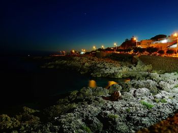 Scenic view of sea against clear sky at night