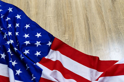 Close-up of american flag on wooden floor
