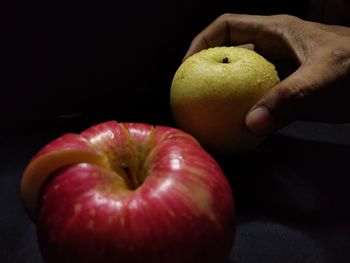 Close-up of hand holding apple