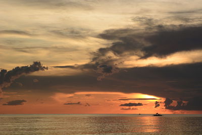 Scenic view of sea against orange sky