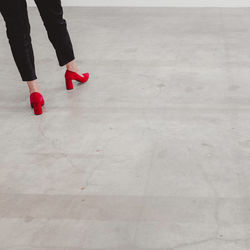 Low section of woman standing on red floor