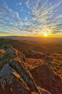 Aerial view of rock formation against sky during sunset