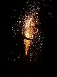 Low angle view of firework display at night