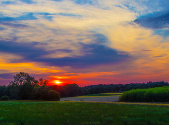 Scenic view of field against sky during sunset