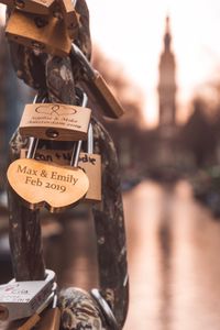 Love locks attached to a bridge in amsterdam with churchtower in the background