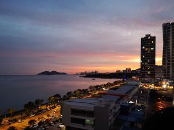 High angle view of illuminated buildings against sky at sunset