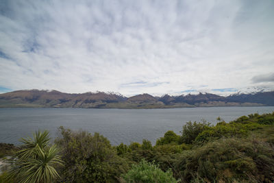 Scenic view of lake and mountains against sky