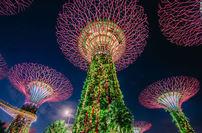 Low angle view of illuminated ferris wheel against sky at night