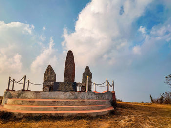 Old ruin on field against sky