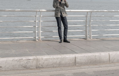 Low section of man standing on footpath