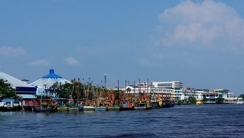 Boats in river with buildings in background