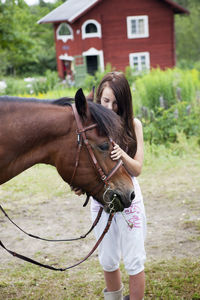 Outdoor portrait of girl with her horse