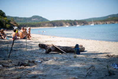 People on beach against sky