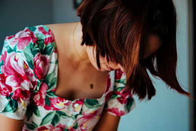 Close-up of woman looking down at home