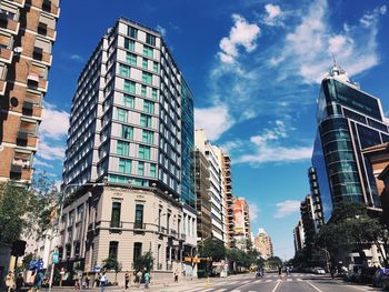 Buildings in city against cloudy sky