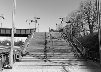 Low angle view of staircase amidst buildings against sky