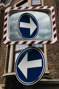 Road sign against blue sky