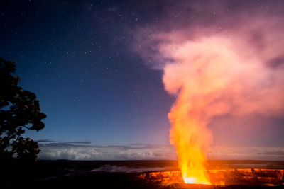 Close-up of fire against sky at night