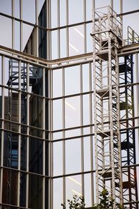 Low angle view of glass building at construction site